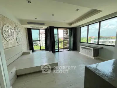 Spacious modern bedroom with large windows and balcony view in luxury apartment