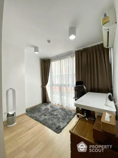 Modern study room with desk, chair, and air purifier, featuring large window and wooden flooring.