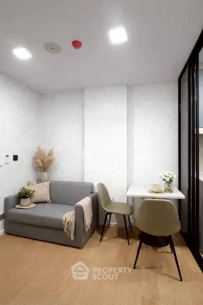 Modern living room with cozy sofa and dining area, perfect for urban living.