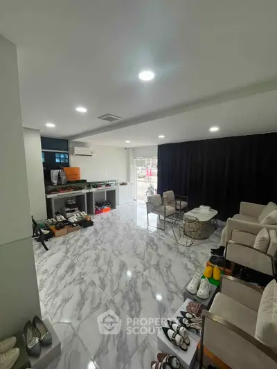 Spacious modern living area with marble flooring and stylish furniture, perfect for contemporary urban living.
