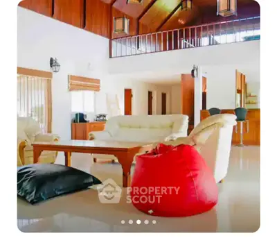 Spacious living room with high ceilings and modern furniture in a luxurious home