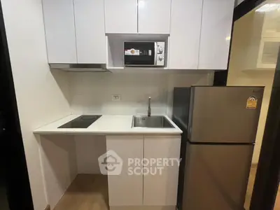 Modern compact kitchen with sleek cabinetry and stainless steel appliances