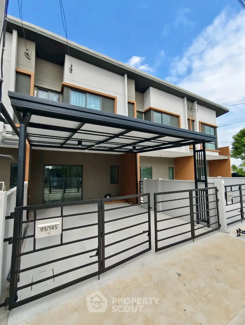Modern townhouse with sleek design and spacious driveway in a serene neighborhood.