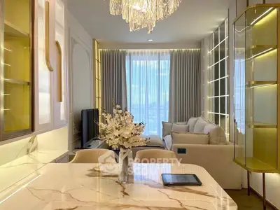 Luxurious modern living room with elegant chandelier and marble dining table, featuring a cozy sofa and large window view.