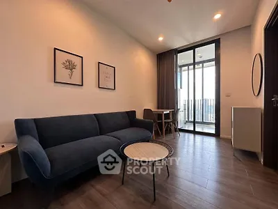 Modern living room with stylish furniture and balcony view in a contemporary apartment.