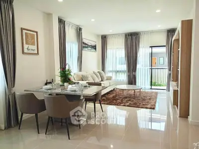 Elegant modern living room with dining area, stylish decor, and ample natural light.