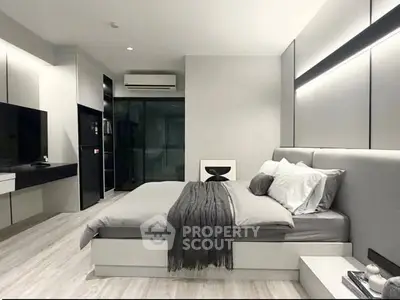 Modern bedroom with sleek design, featuring a cozy bed, stylish decor, and ambient lighting for ultimate relaxation.