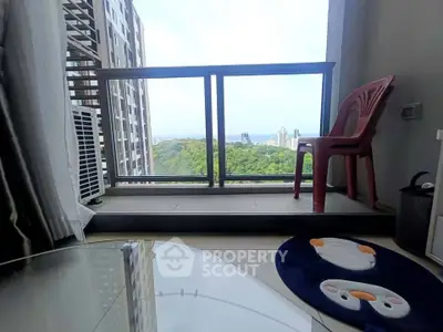 Modern apartment balcony with city view and cozy seating area.