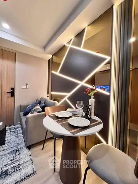 Modern living room with stylish lighting and cozy dining area in a contemporary apartment.