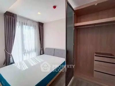 Modern bedroom with natural light and built-in wardrobe, perfect for cozy living.