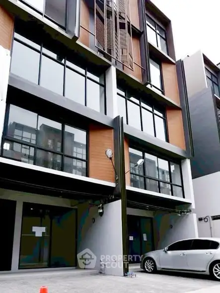 Modern multi-story building with sleek design and large windows