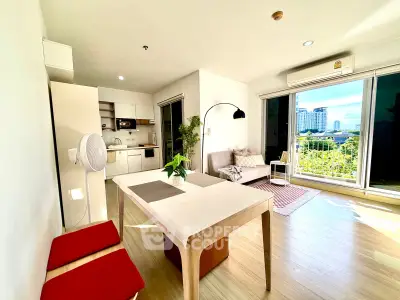 Spacious modern living room with open kitchen and balcony view in urban apartment