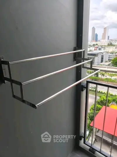 Modern balcony with city view and sleek metal drying rack, perfect for urban living.