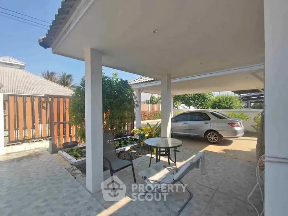 Charming carport with seating area in a serene residential setting