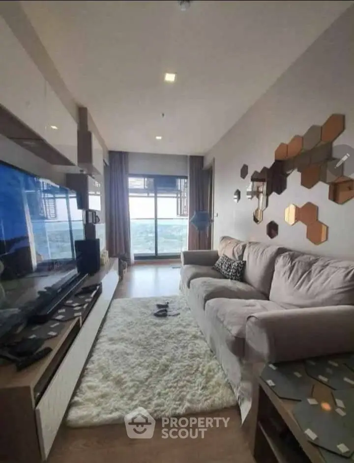 Modern living room with cozy sofa and stunning sea view through large window.