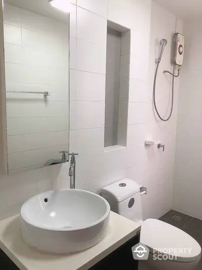 Modern bathroom with sleek white tiles and contemporary fixtures