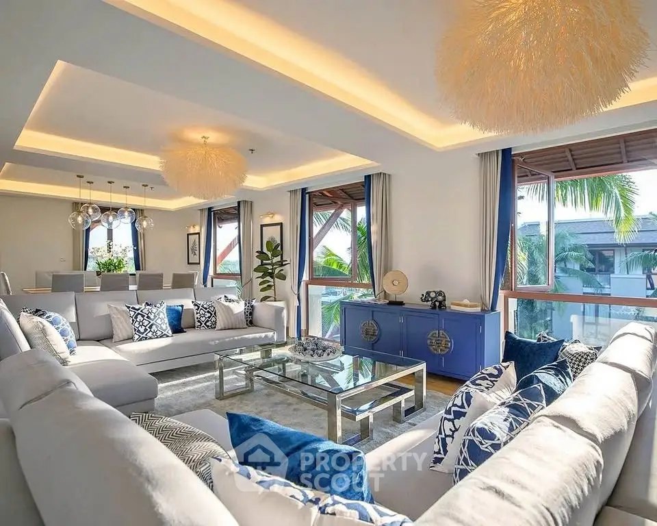 Luxurious living room with modern decor and large windows offering a stunning view.