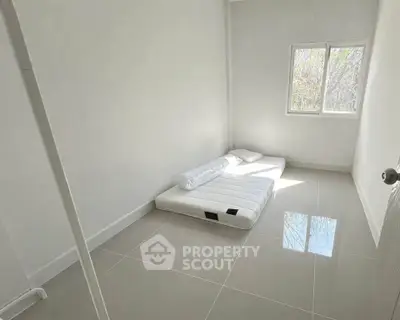 Minimalist bedroom with floor mattress and natural light