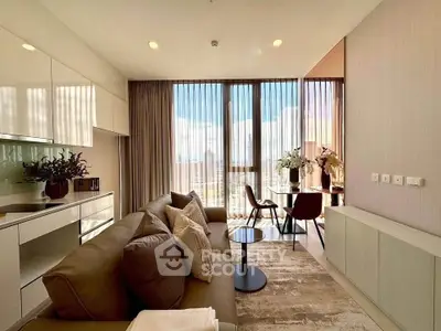 Modern living room with large windows and stunning city view, featuring elegant furniture and decor.