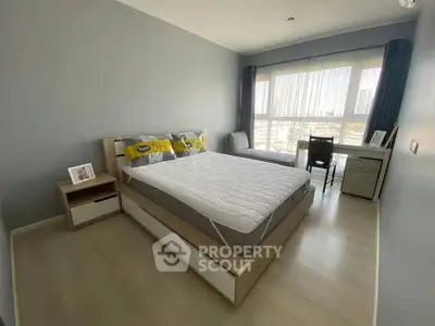 Modern bedroom with large window and stylish decor in urban apartment