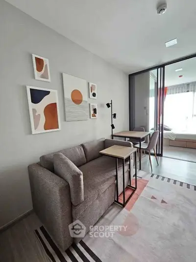 Modern living room with stylish decor and cozy seating in a contemporary apartment.
