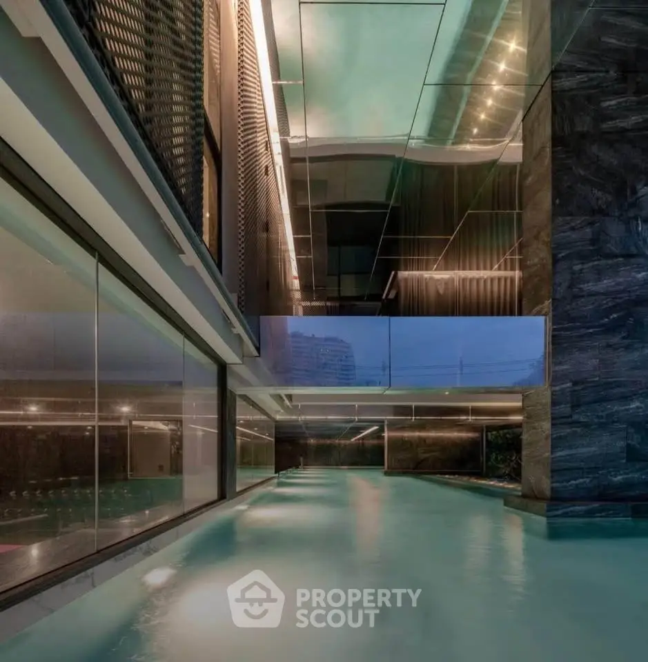 Luxurious indoor pool with modern architectural design and ambient lighting
