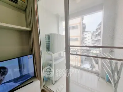 Modern apartment balcony with city view and air conditioning units