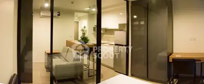 Modern studio apartment with open kitchen and cozy living area, featuring sleek design and efficient use of space.
