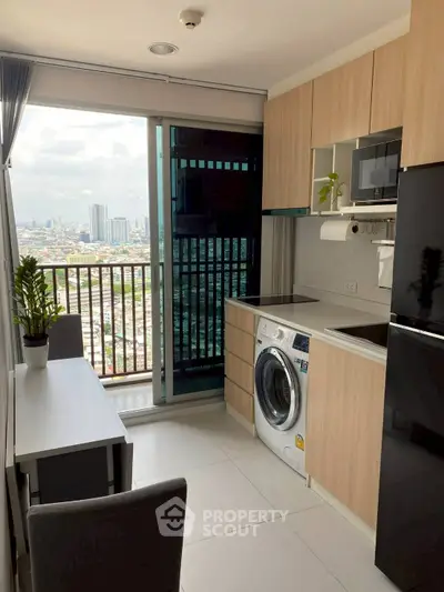 Modern kitchen with city view, featuring sleek appliances and a washing machine, perfect for urban living.
