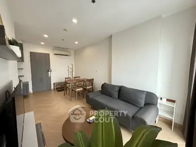 Modern living room with stylish furniture and natural light, perfect for relaxation and entertainment.