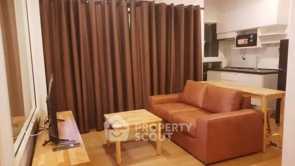 Cozy living room with brown sofa and open kitchen layout