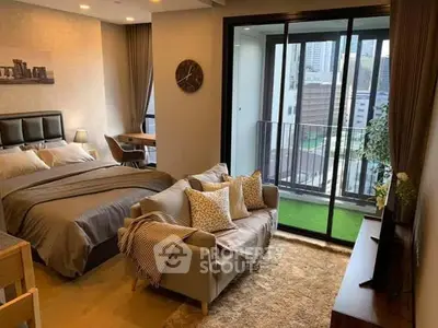 Modern bedroom with cozy seating area and city view balcony