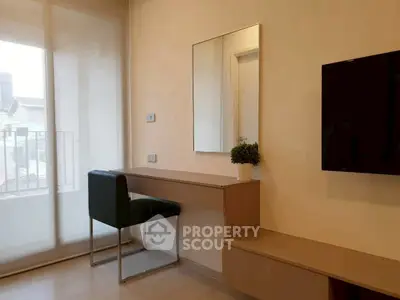 Modern bedroom with sleek furniture and large window for natural light