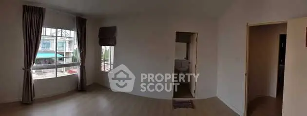 Spacious unfurnished room with large windows and natural light, ideal for customization.