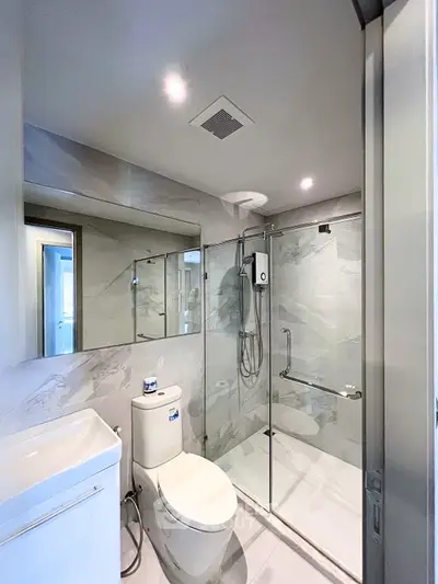 Modern bathroom with sleek design, glass shower enclosure, and elegant fixtures in a contemporary home.