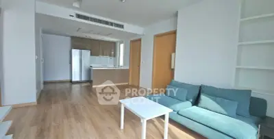 Modern living room with open kitchen and stylish furniture