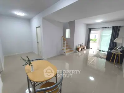 Spacious modern living room with natural light and sleek tile flooring
