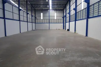 Spacious industrial warehouse with high ceilings and ample natural light.