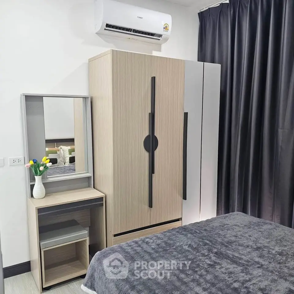 Modern bedroom with sleek wardrobe and cozy bed setup