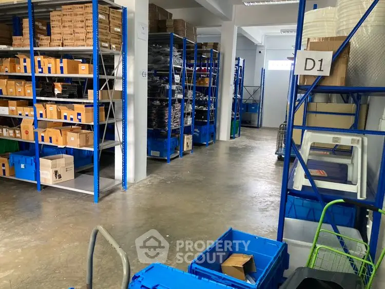 Spacious warehouse storage area with organized shelving and boxes, ideal for efficient inventory management.
