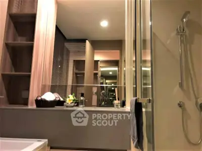 Modern bathroom with sleek shower and elegant fixtures in luxury apartment.
