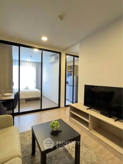 Modern apartment interior with open living room and bedroom view