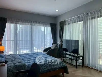 Modern bedroom with large windows offering stunning city views and natural light.