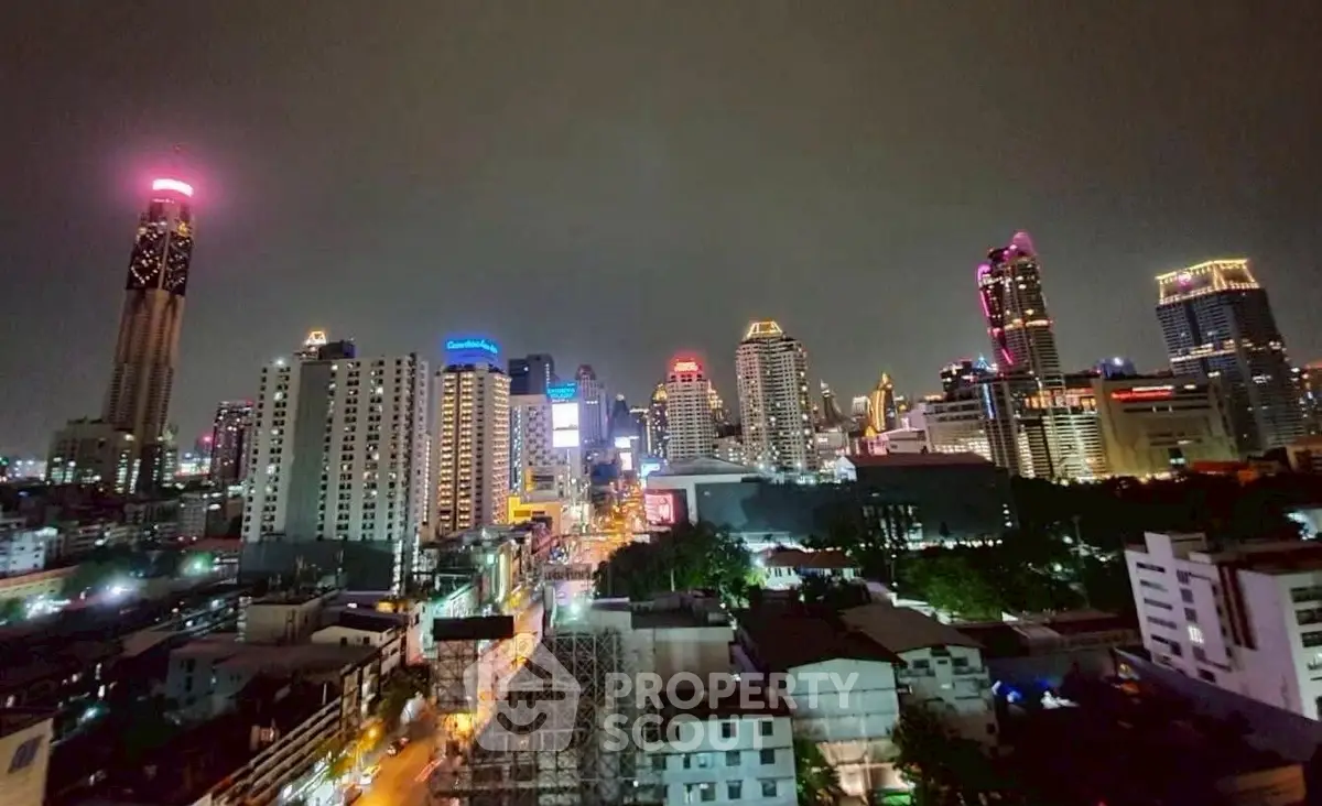 Stunning cityscape view of illuminated skyscrapers at night, showcasing vibrant urban living.