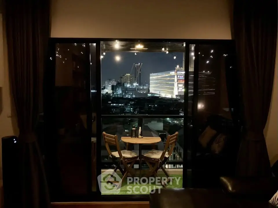 Cozy balcony with city view, perfect for evening relaxation.