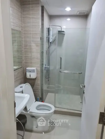 Modern bathroom with glass shower and sleek fixtures