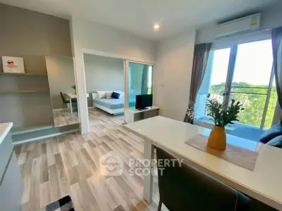 Modern open-plan living room with balcony view and stylish decor