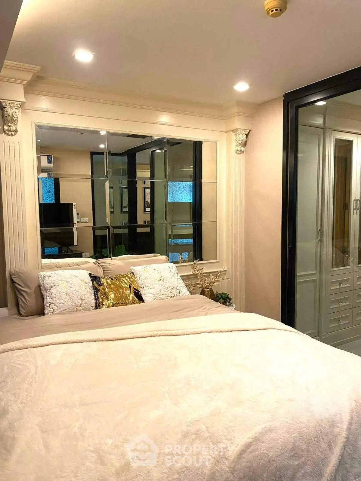 Luxurious bedroom with elegant decor and mirrored wall accents