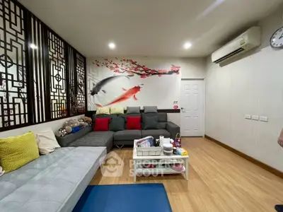 Stylish living room with Asian-inspired decor and cozy seating area.