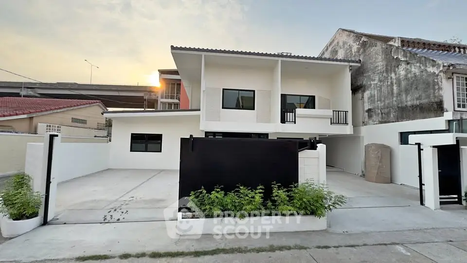 Modern two-story house with clean facade and spacious driveway